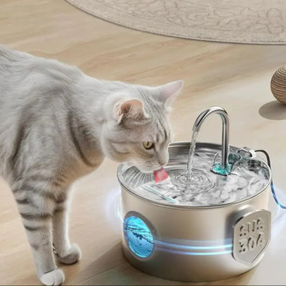 Cat drinking from ultra-quiet pet water fountain on wooden floor