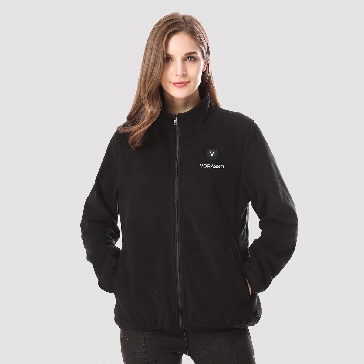 Woman wearing the VORASSO heated fleece jacket in black
